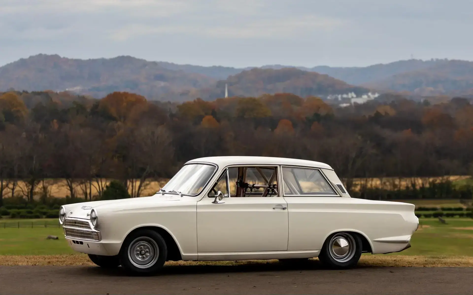 1966 Ford Cortina race car side profile showing Retroford steel wheels with Toyo R888R tires and lowered suspension