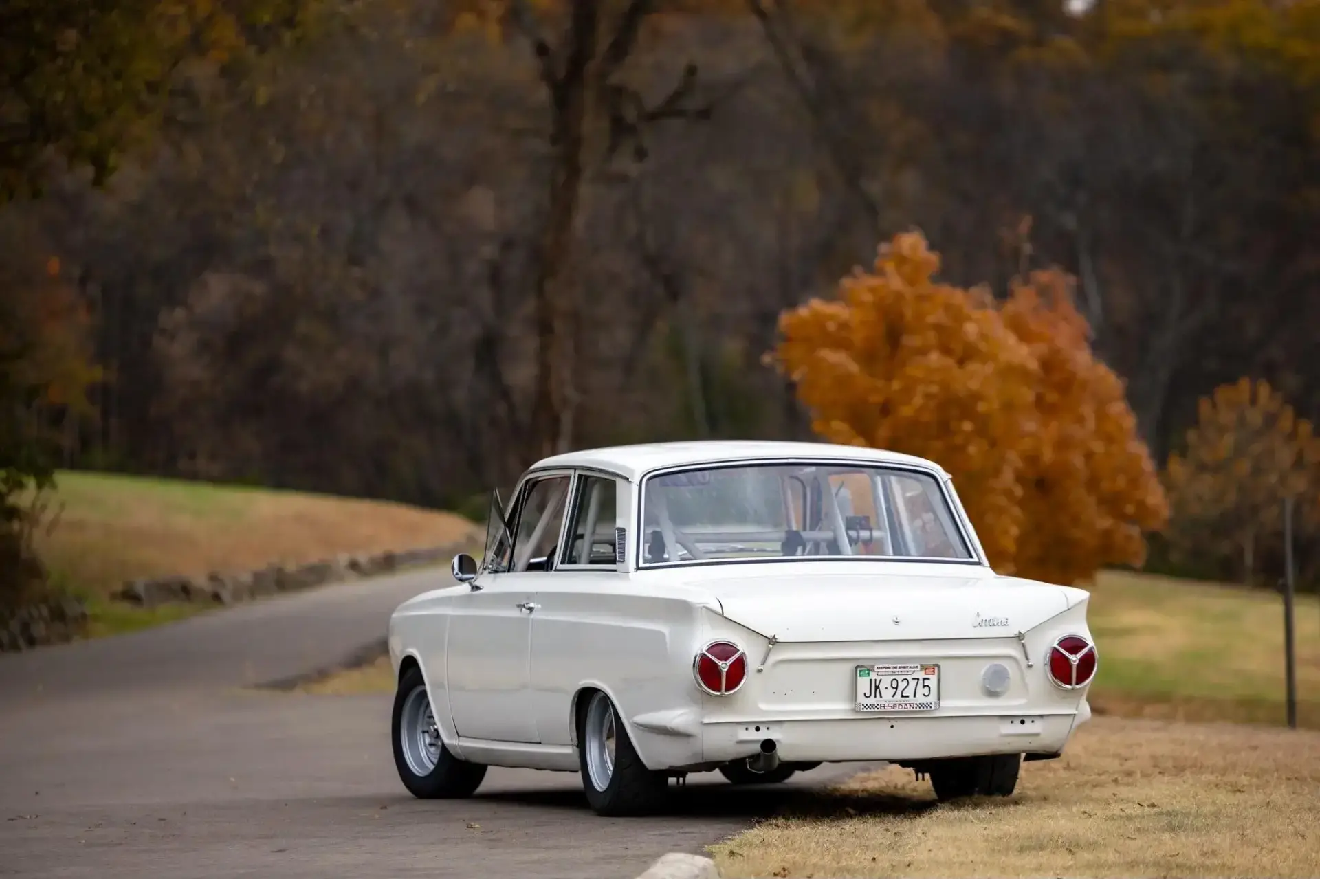 1966 Ford Cortina race car rear three-quarter view showing Ermine White paint with race preparation and period details