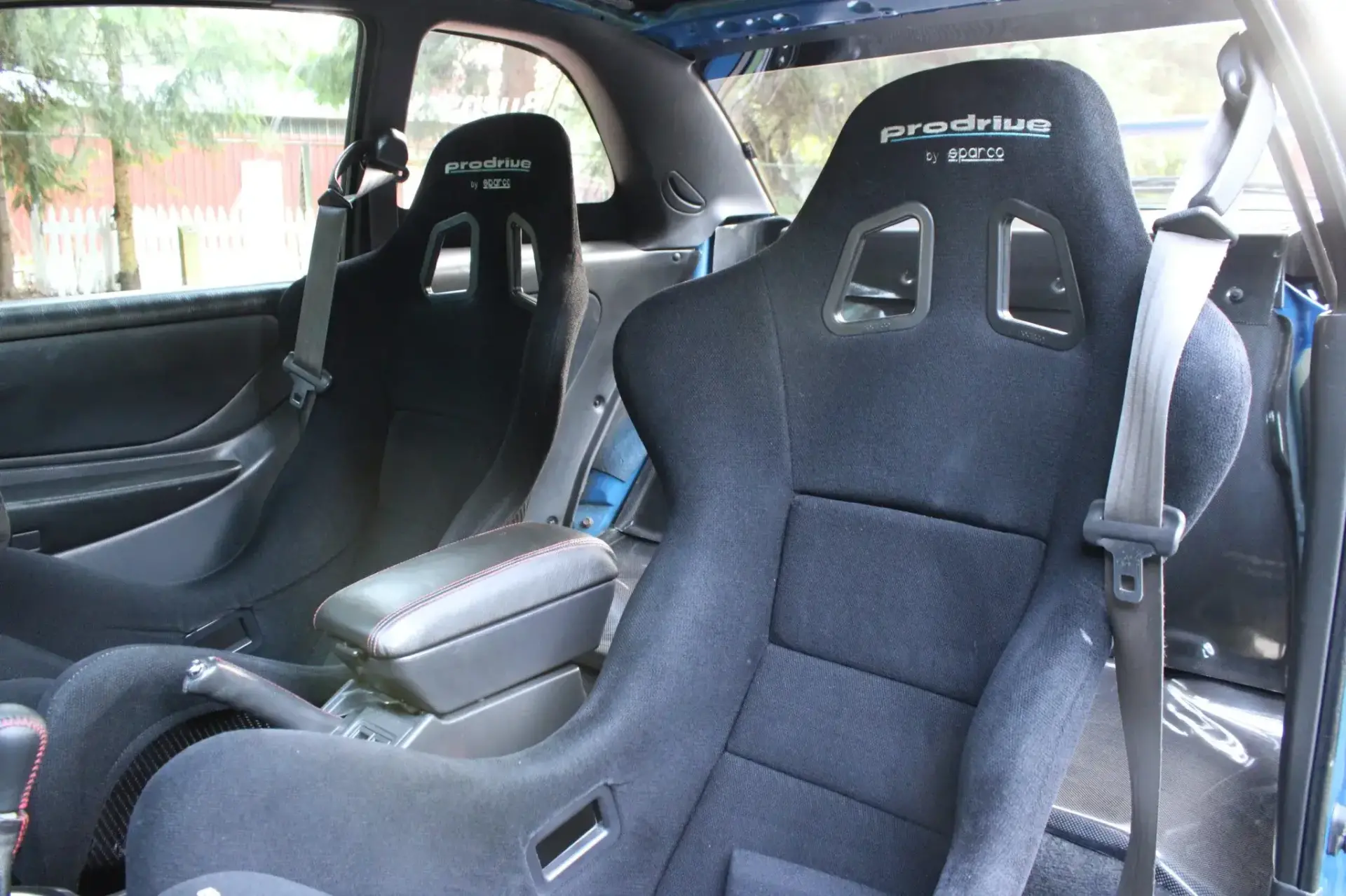 Right-hand drive Sparco carbon fiber bucket seats and STi instrument cluster in modified Subaru Impreza interior