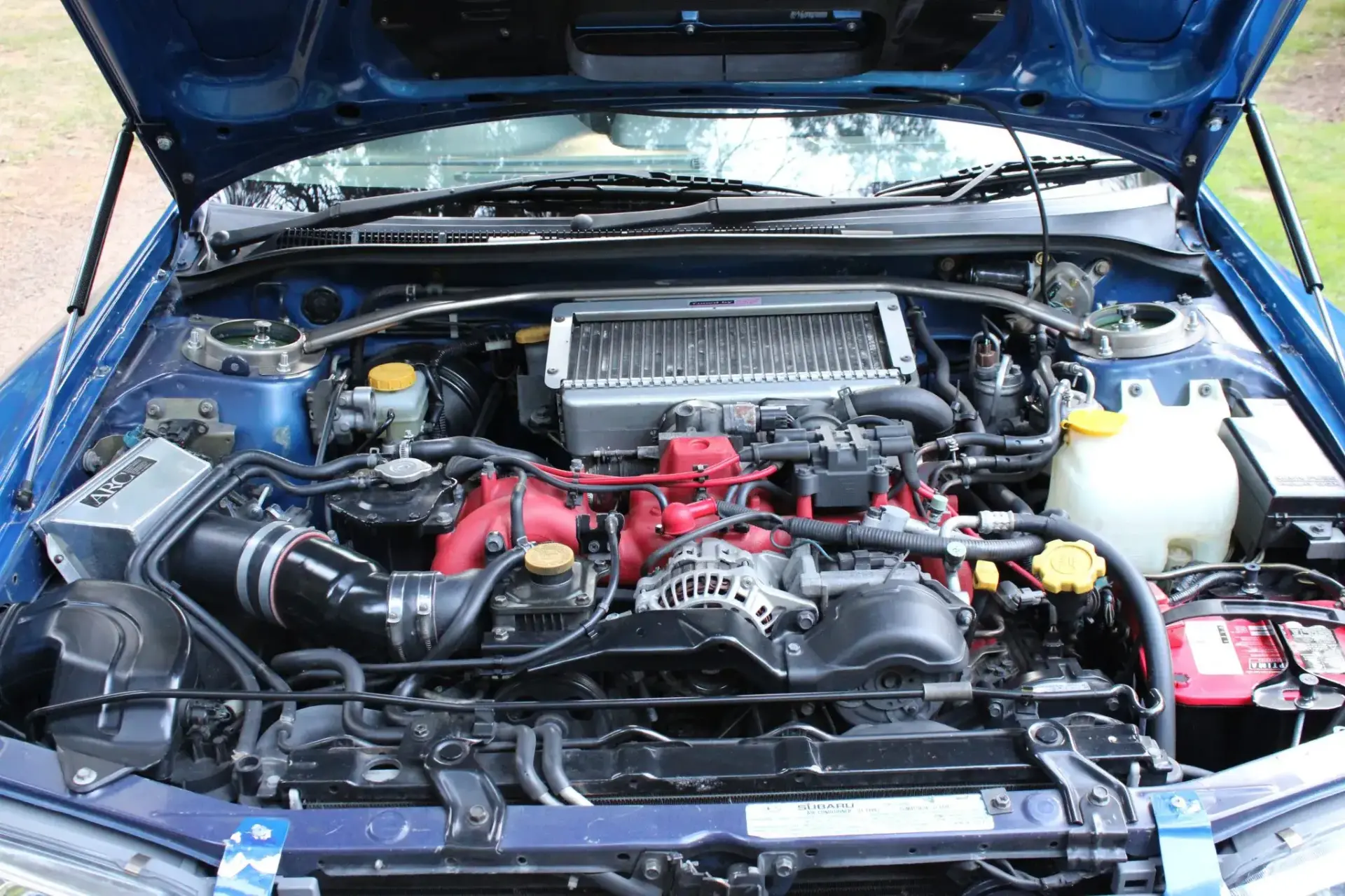 STi EJ207 turbo engine bay in modified 1999 Subaru Impreza 2.5RS showing performance upgrades and engine swap