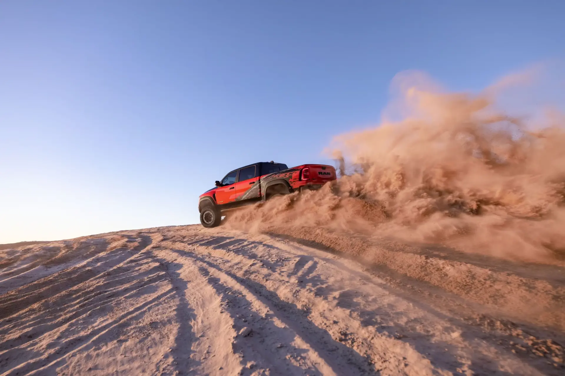 2027 Ram TRX rear three-quarter view showing revised tailgate badge with T-Rex logo and dual exhaust