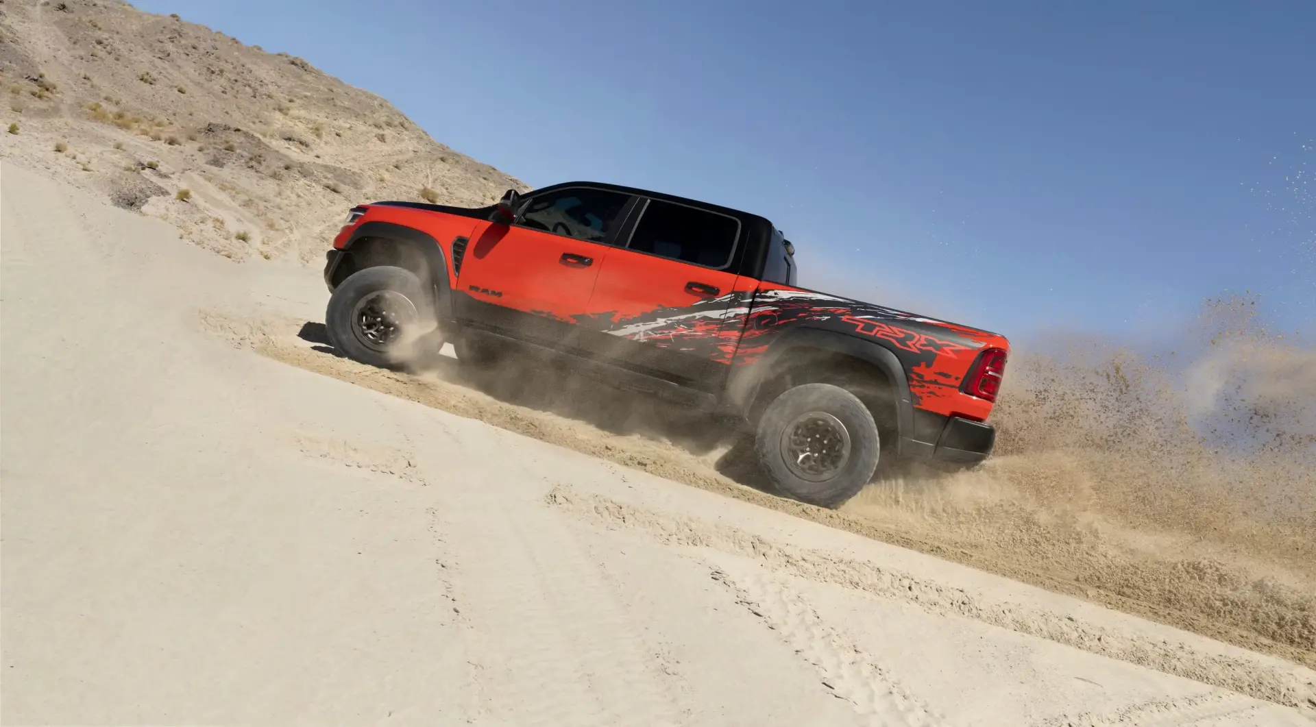 2027 Ram TRX suspension detail showing Bilstein Black Hawk e2 adaptive dampers and 35-inch Goodyear tires