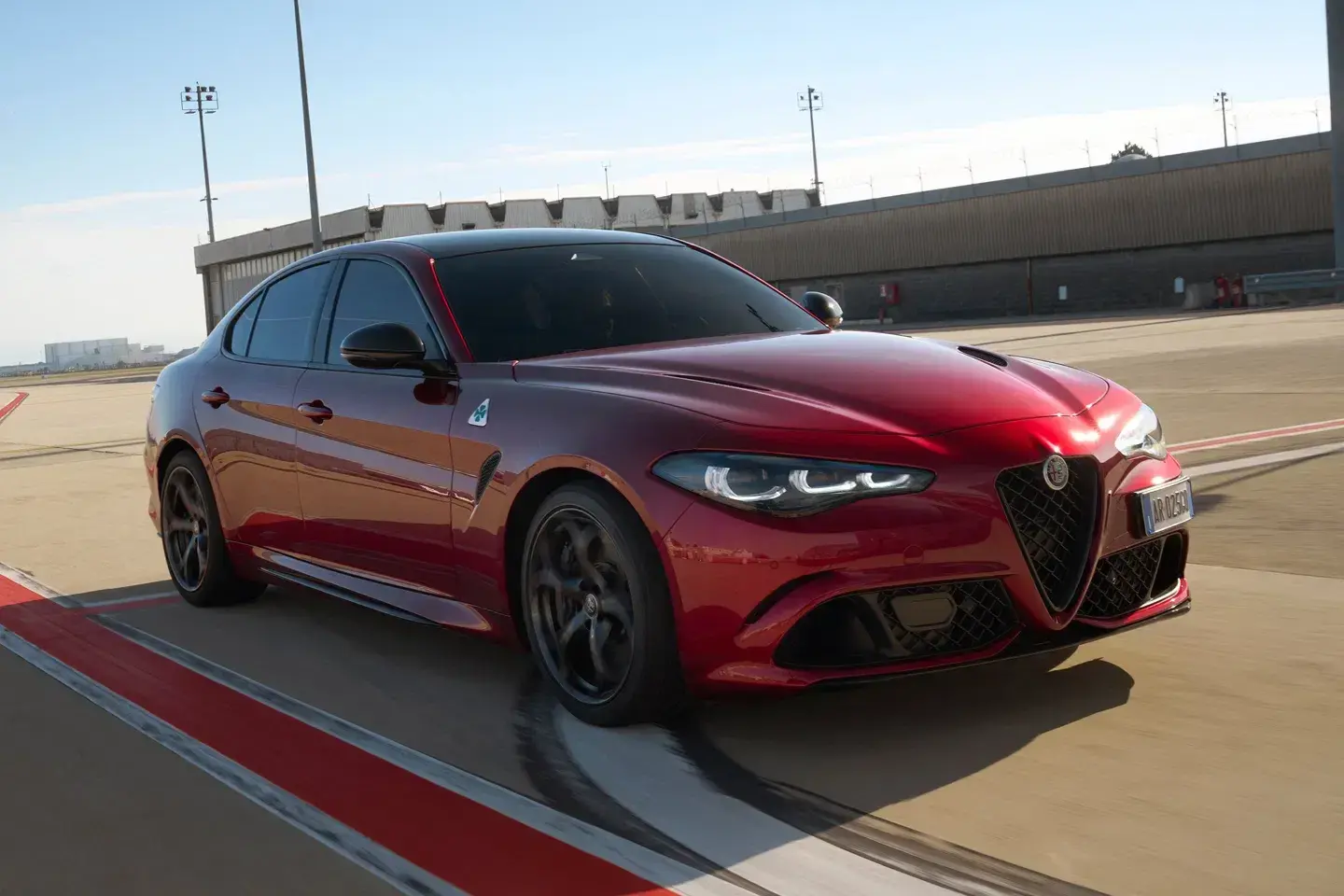 2024 Alfa Romeo Giulia Collezione limited edition in exclusive Rosso Collezione red showing aggressive front fascia and quad headlights