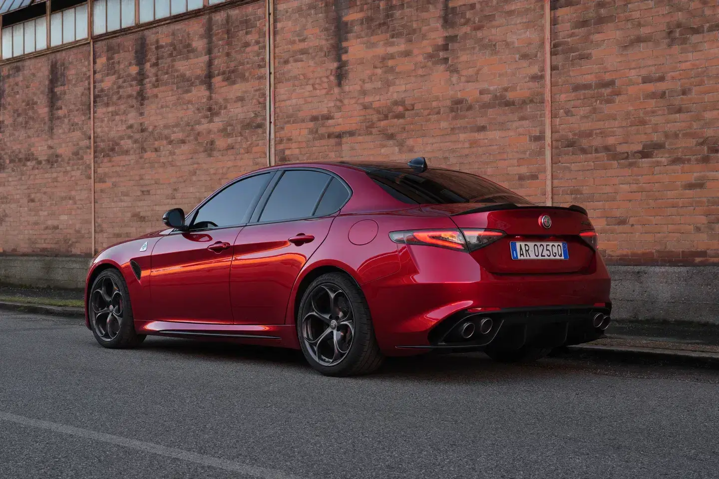 2024 Alfa Romeo Giulia Collezione rear three-quarter view showing quad exhaust outlets and sporty stance with low profile