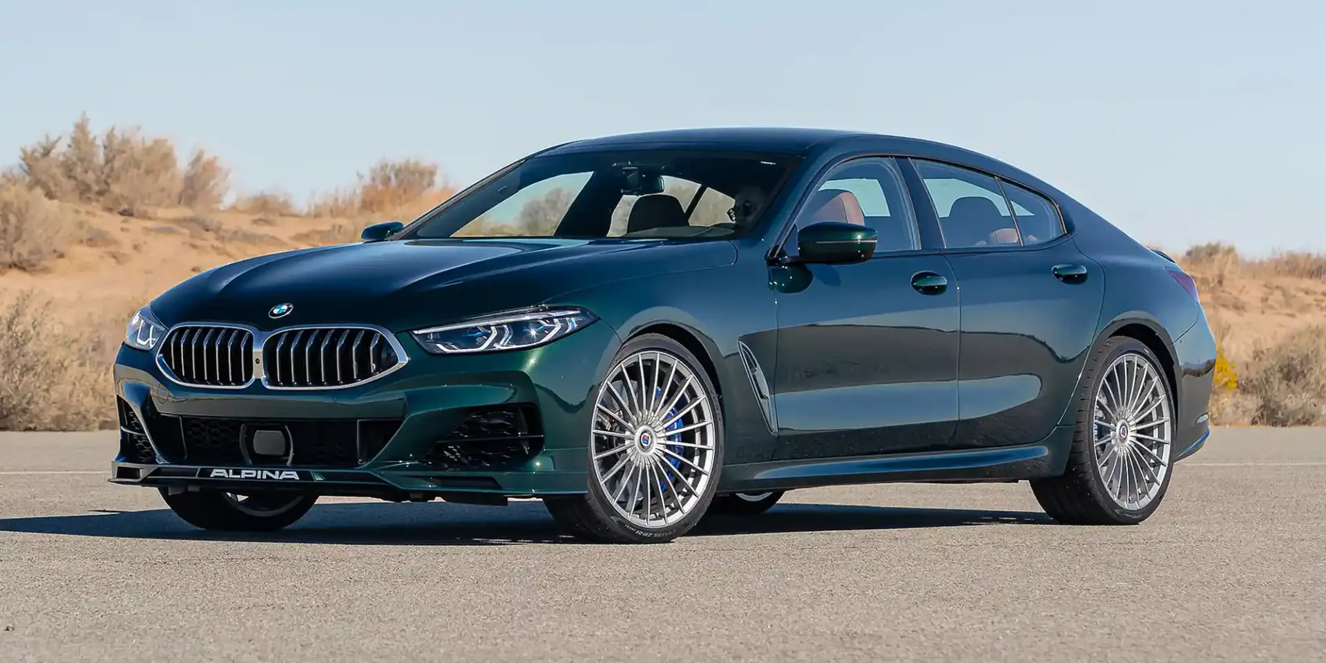 Classic BMW Alpina sedan with iconic multi-spoke alloy wheels and subtle body modifications showcasing the brand's heritage