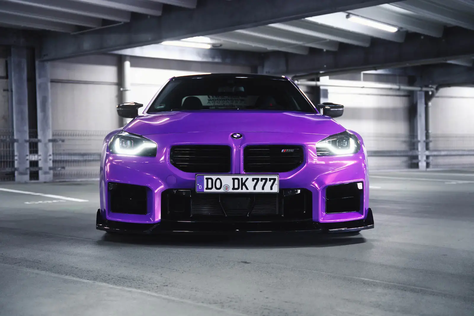 BMW M2 G87 by MrSpectrum rear three-quarter view highlighting deep concave wheels, lowered stance, and Royalty Purple wrap finish