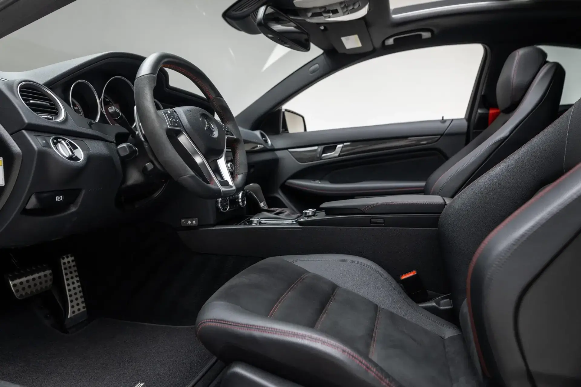 2012 Mercedes-Benz C63 AMG Black Series dashboard with COMAND infotainment system and carbon fiber interior accents