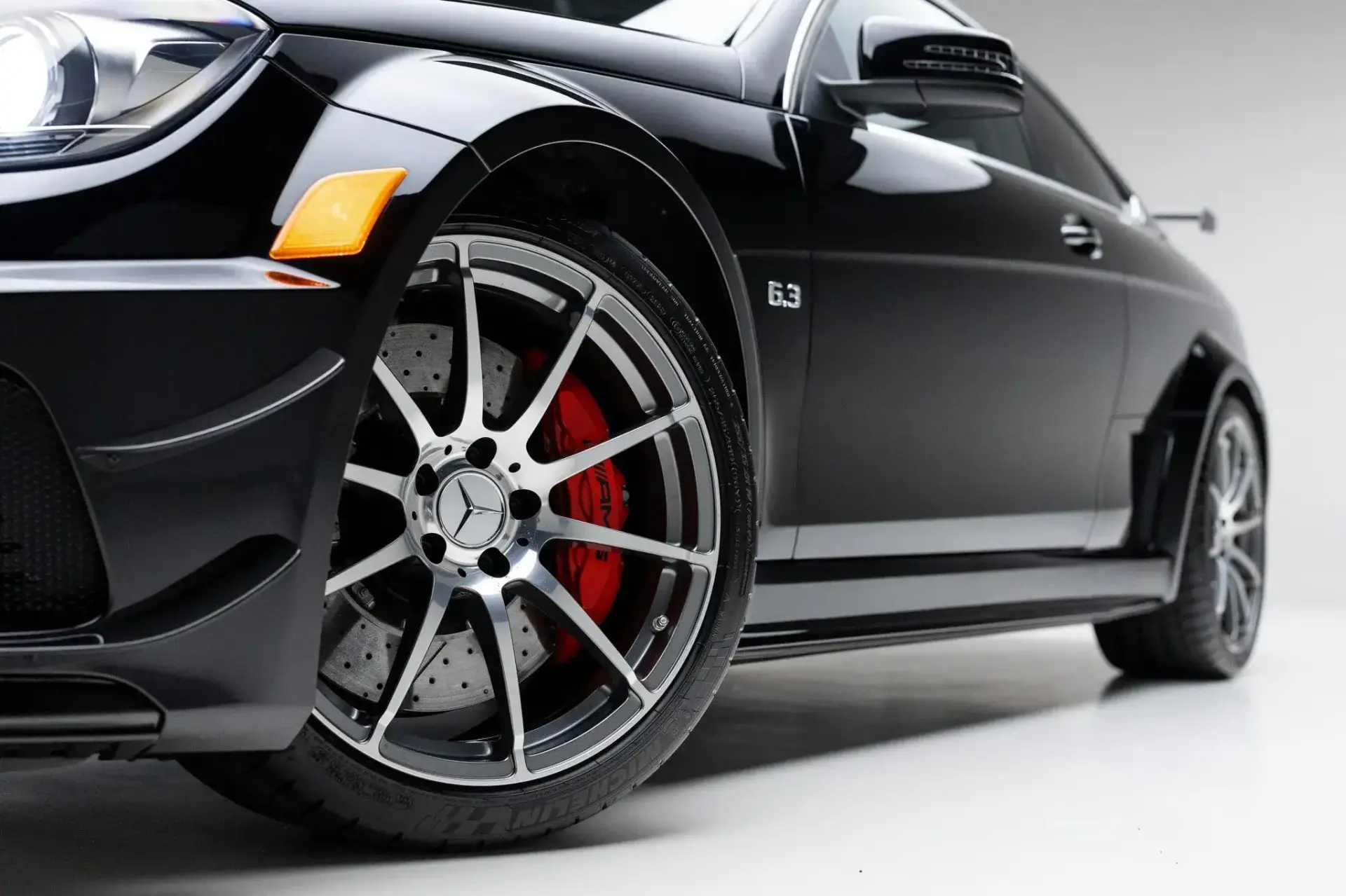 2012 Mercedes-Benz C63 AMG Black Series rear view displaying adjustable carbon fiber wing and quad exhaust system