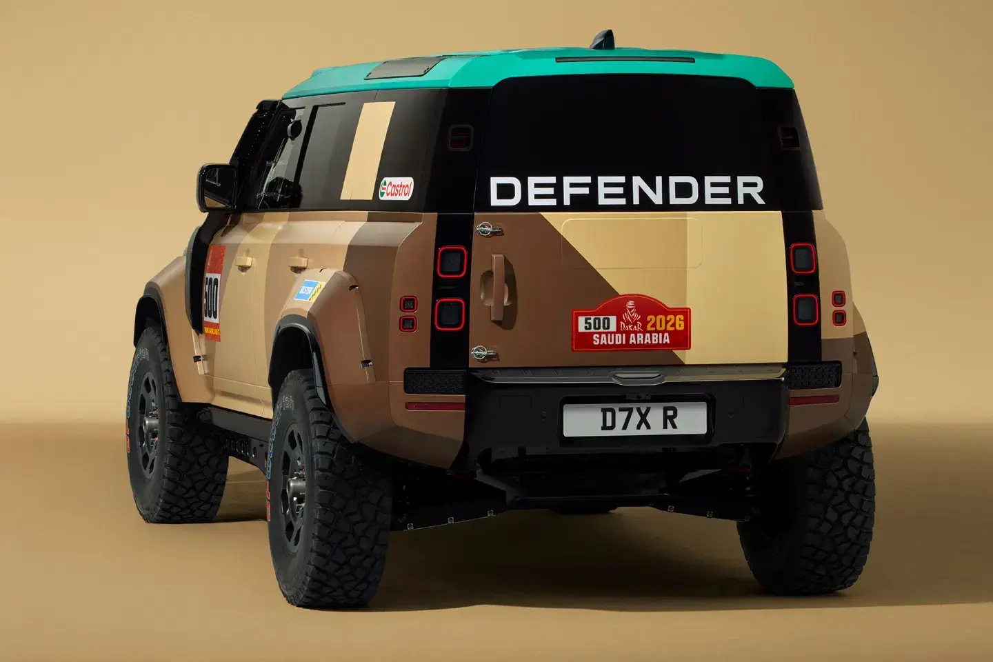 2026 Land Rover Defender D7X-R showing widened composite arches and 35-inch all-terrain tires with desert suspension