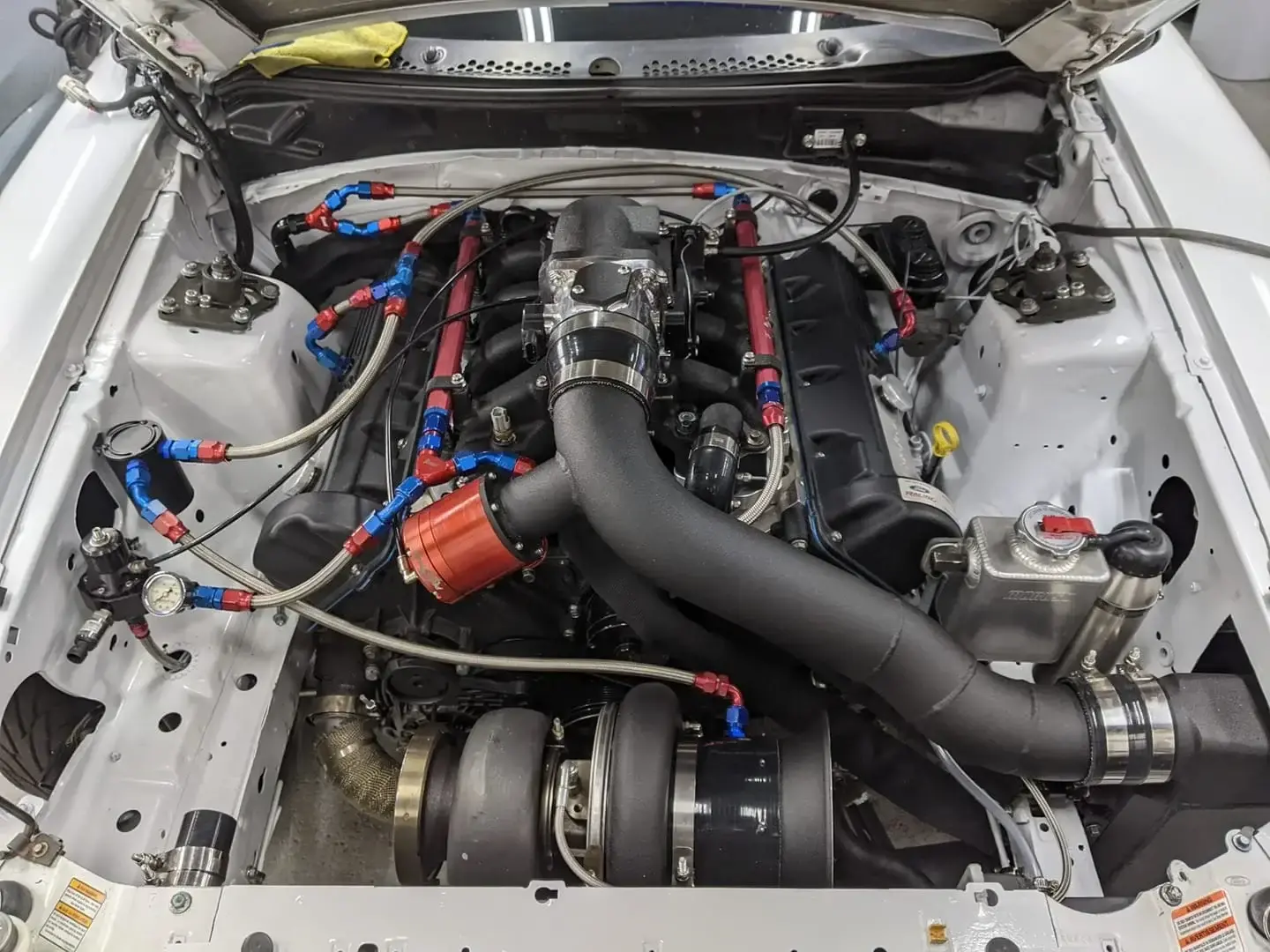 Classic Ford Mustang with modern Coyote V8 engine swap installation