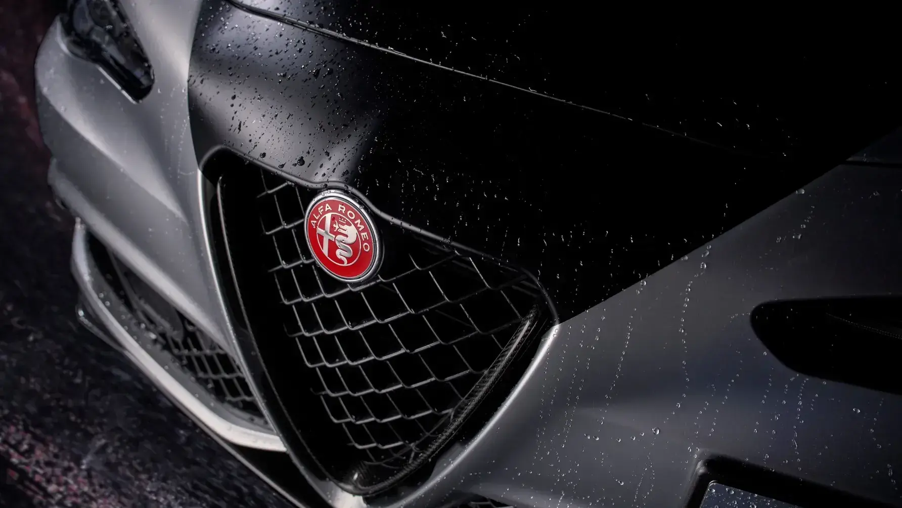 Alfa Romeo Giulia Quadrifoglio Luna Rossa side profile highlighting carbon fiber aerodynamic elements and 19-inch wheels