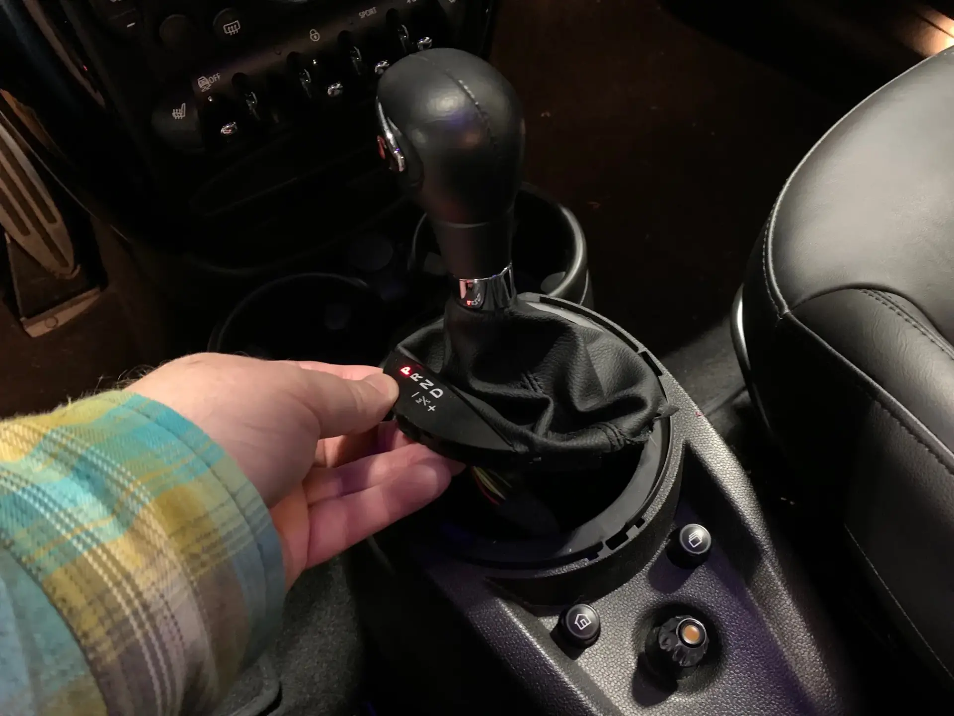 Aftermarket weighted shift knob installed in sports car interior