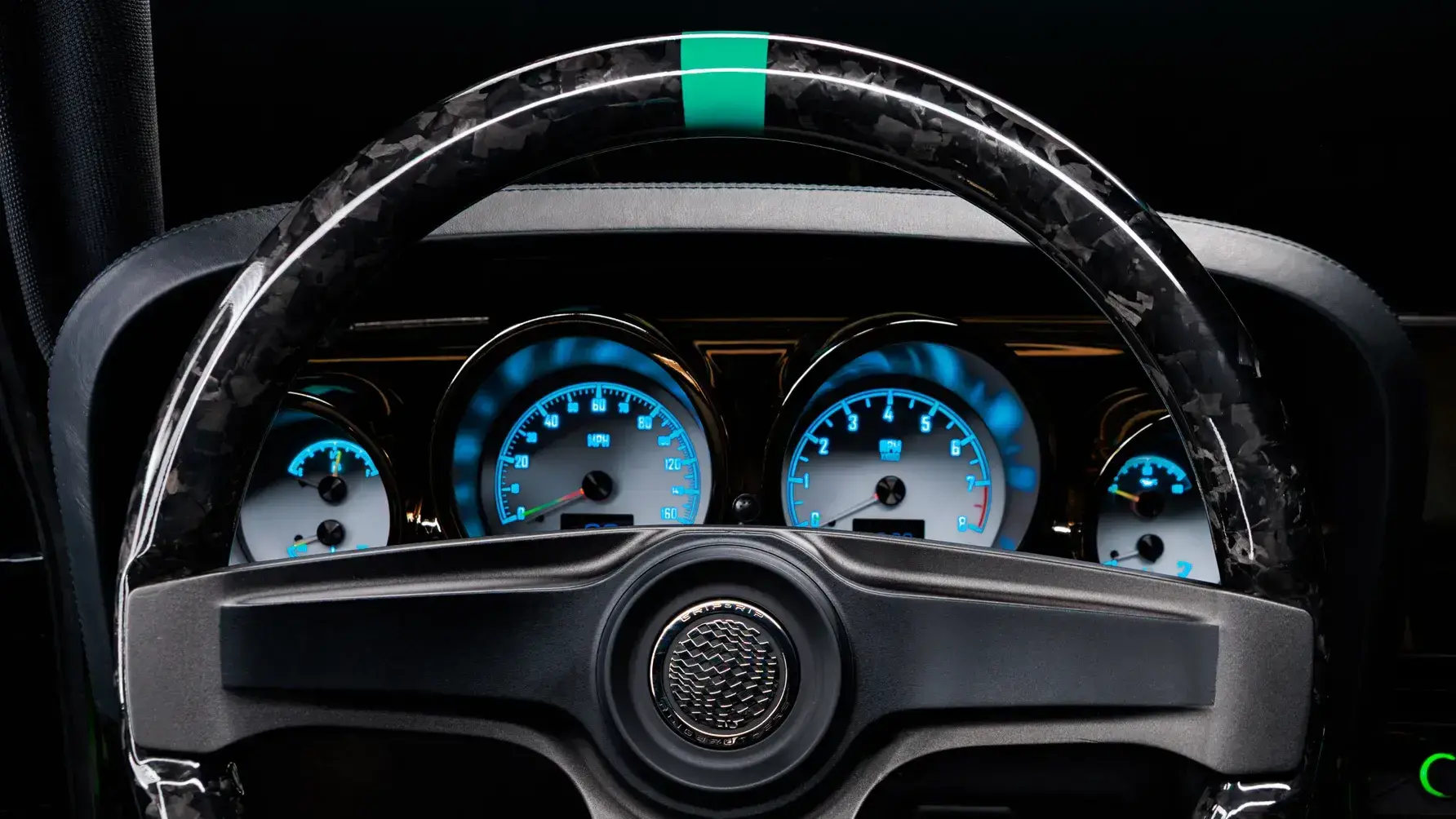 Ringbrothers KINGPIN Mustang custom interior featuring roll cage, crushed carbon steering wheel, Dakota Digital gauges, and Grab-Her Green trim