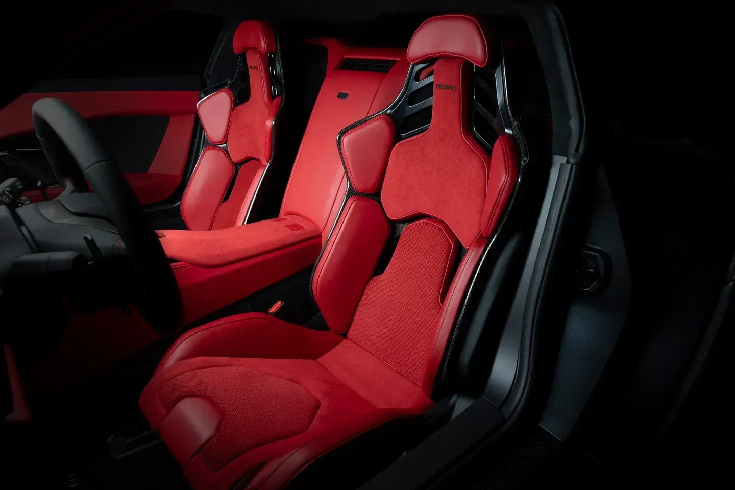 Toyota GR GT interior showing carbon-backed Recaro bucket seats, racing steering wheel, digital displays, and driver-focused cockpit layout