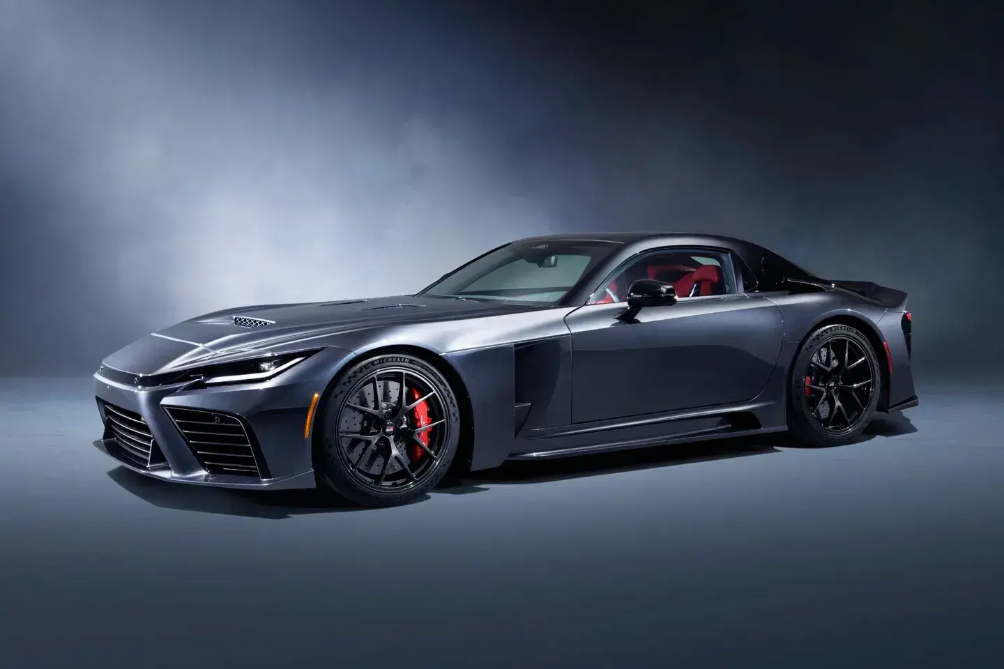 Toyota GR GT rear three-quarter view showcasing quad exhaust system, active rear wing, and GT3-inspired aerodynamic elements