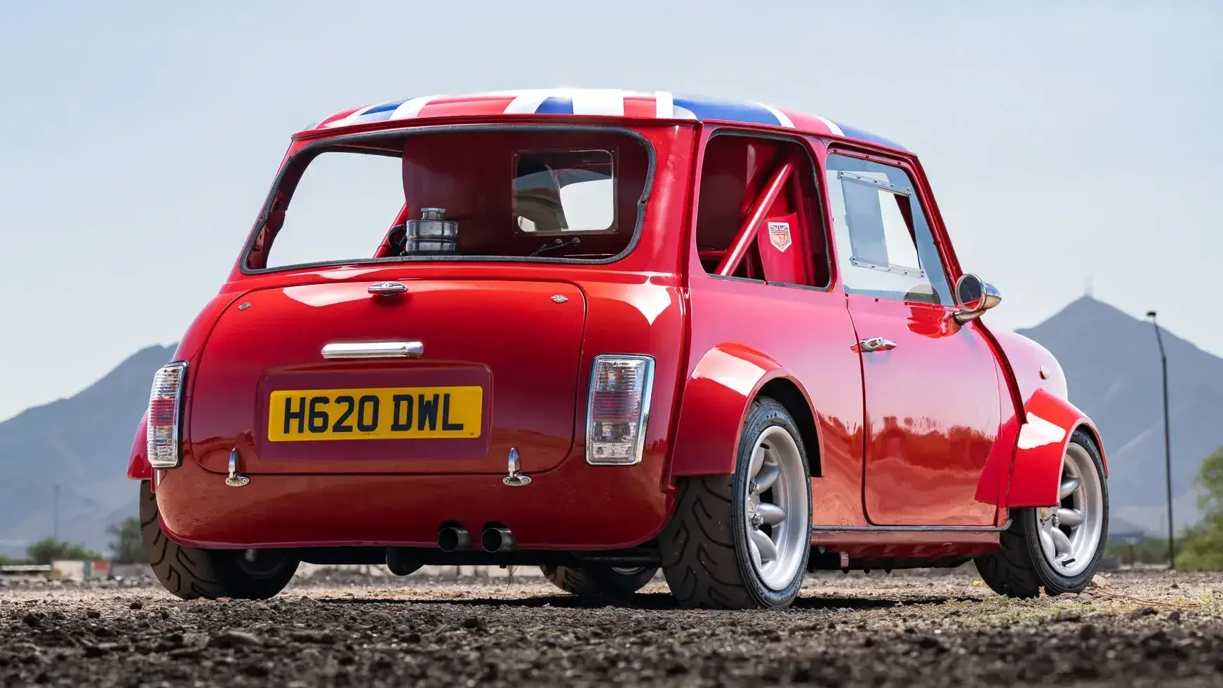 Rear three-quarter view of modified 1990 Rover Mini Mayfair Twini showing lightweight body panels and racing wheels