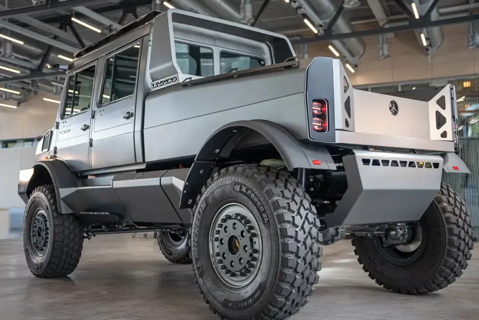 Mercedes-Benz Unimog rear three-quarter view showing large expedition pickup bed and rugged off-road construction